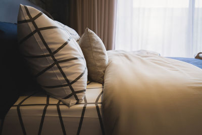 Pillows and blanket on bed at home