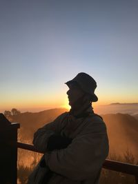 Silhouette man standing against sky during sunset