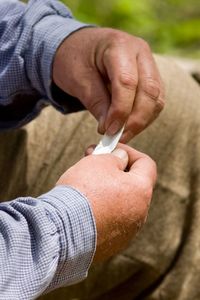 Close-up of man hands folding paper