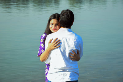 Happy woman standing in lake