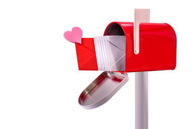 Close-up of red heart shape over white background