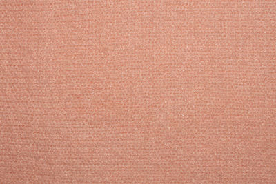 Close up photo of pink knitted sweater texture as abstract background.