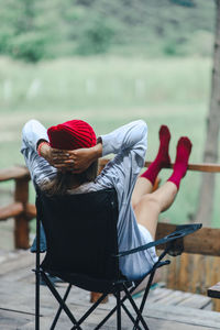 Rear view of woman sitting on chair