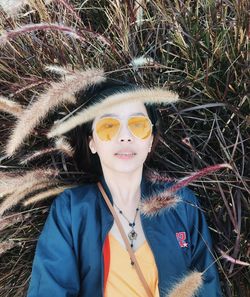 Portrait of woman wearing sunglasses on field