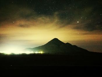 Scenic view of mountains against sky at night