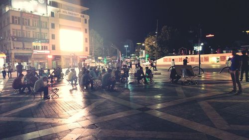 Crowd at illuminated city at night