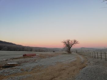 Scenic view of landscape against clear sky during sunset