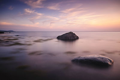 Scenic view of sea against sky at sunset