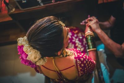 Rear view of woman wearing in sari sitting at home