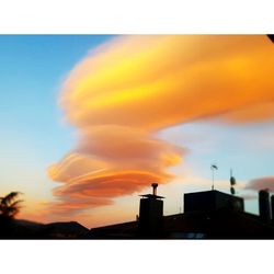 Low angle view of silhouette buildings against sky during sunset