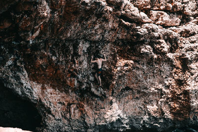 High angle view of man climbing on rock formation