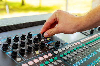 Close-up of cropped hand using sound mixer