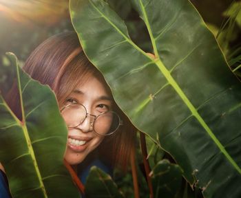 Portrait of a smiling young woman with leaves