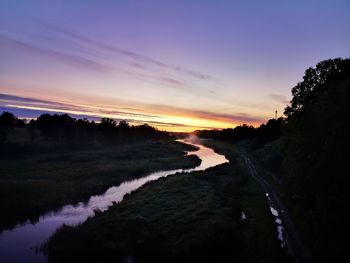 Scenic view of landscape against sky at sunset