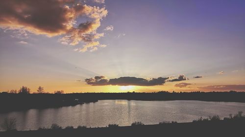 Scenic view of lake against sky during sunset