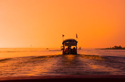 Scenic view of sea against orange sky