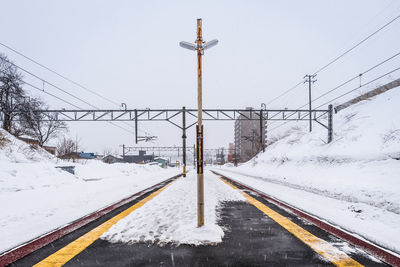 Snow covered road against sky