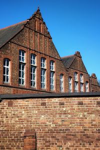 Low angle view of building against clear blue sky