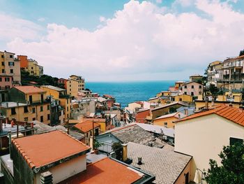 High angle view of townscape by sea against sky