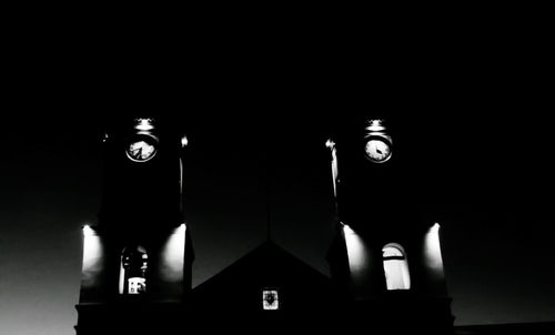 Low angle view of illuminated lamp in darkroom