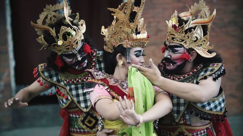 Midsection of woman holding mask