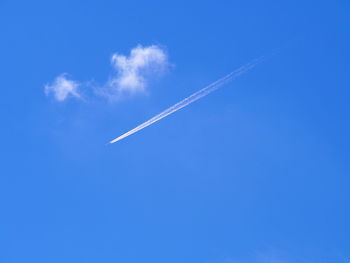 Low angle view of vapor trail against clear blue sky