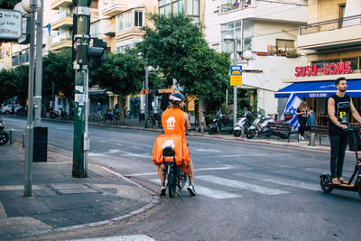 Rear view of man with bicycle on street