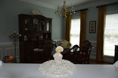 Flower vase on table by window at home