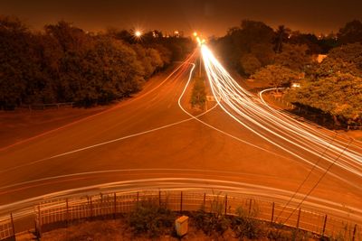 Light trails of moving traffic on road at night