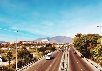 Vehicles on road with mountain in background