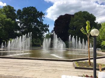 Fountain and trees against sky