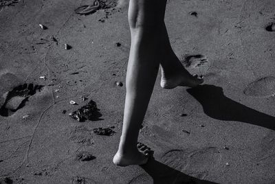 Low section of woman standing on beach