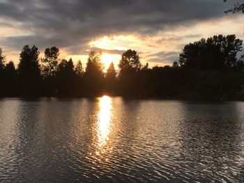 Scenic view of lake against sky during sunset