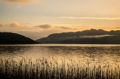 Scenic view of lake against sky during sunset