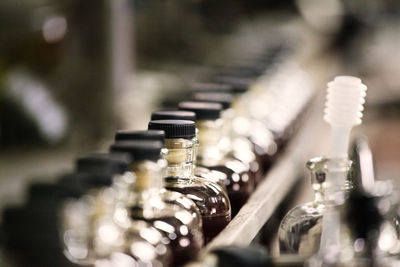 Close-up whiskey bottles in cider at distillery