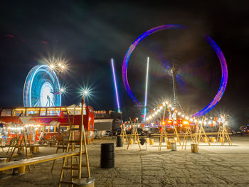 Illuminated ferris wheel at night