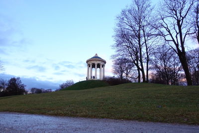 Built structure on field against sky