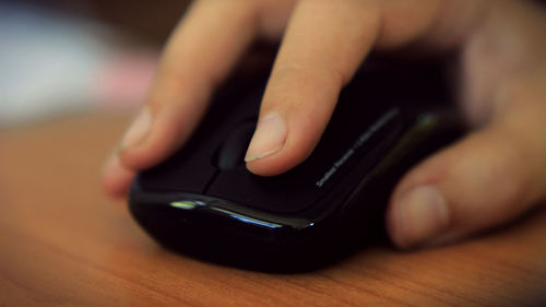 Cropped hand holding computer mouse