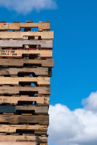 Low angle view of stack against blue sky