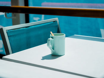 High angle view of drink on table by swimming pool