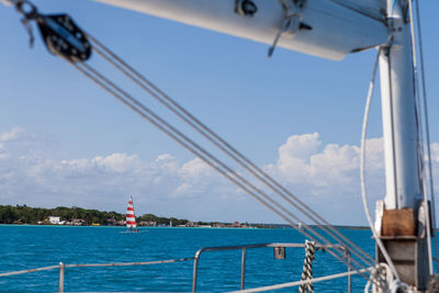 Sailboat sailing in sea against sky