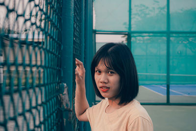 Portrait of woman looking through window