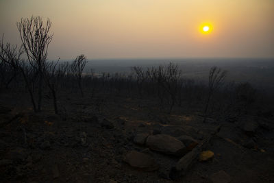 Scenic view of land against sky during sunset