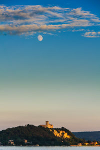 Scenic view of buildings against sky at sunset