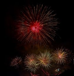 Low angle view of firework display at night