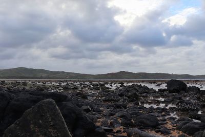 Rocks on land against sky