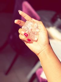 Close-up of woman hand holding ice