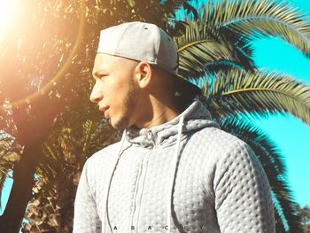 Portrait of young man looking away outdoors