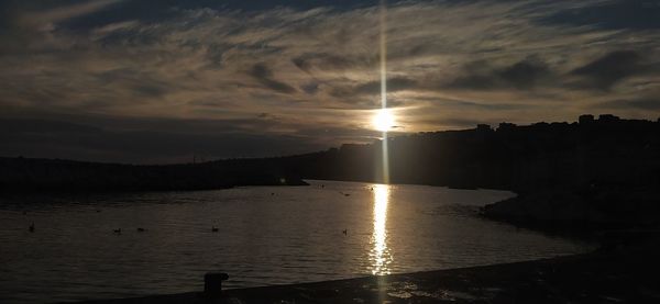 Scenic view of lake against sky during sunset