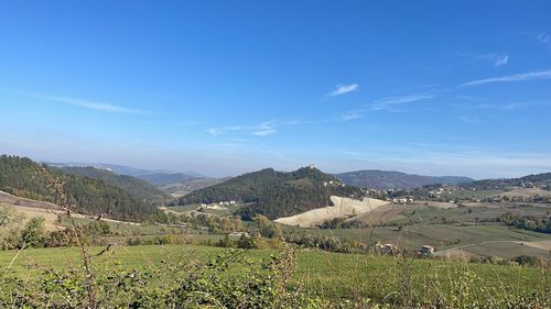 Scenic view of landscape against blue sky